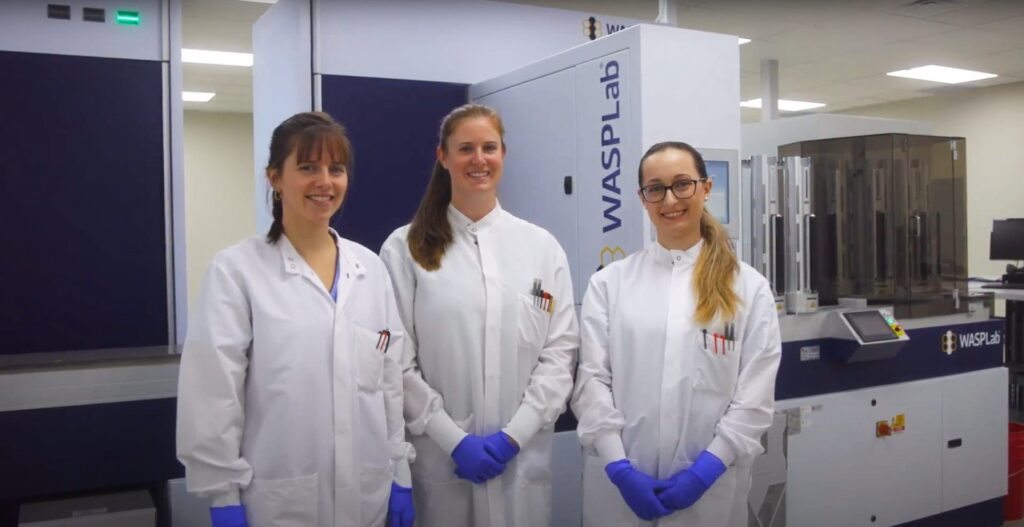 Interpath WASP Lab team in lab coats standing next to each other in a line