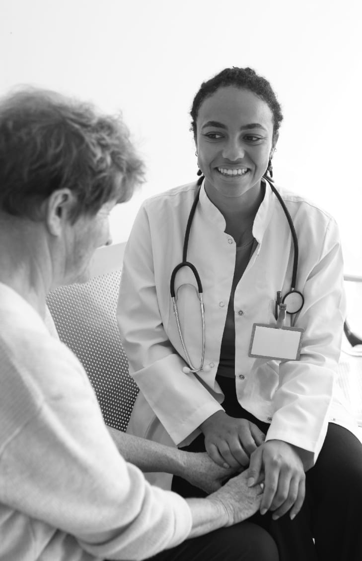 Medicare LCD ICD 10, doctor smiling at patient, patient facing towards the doctor